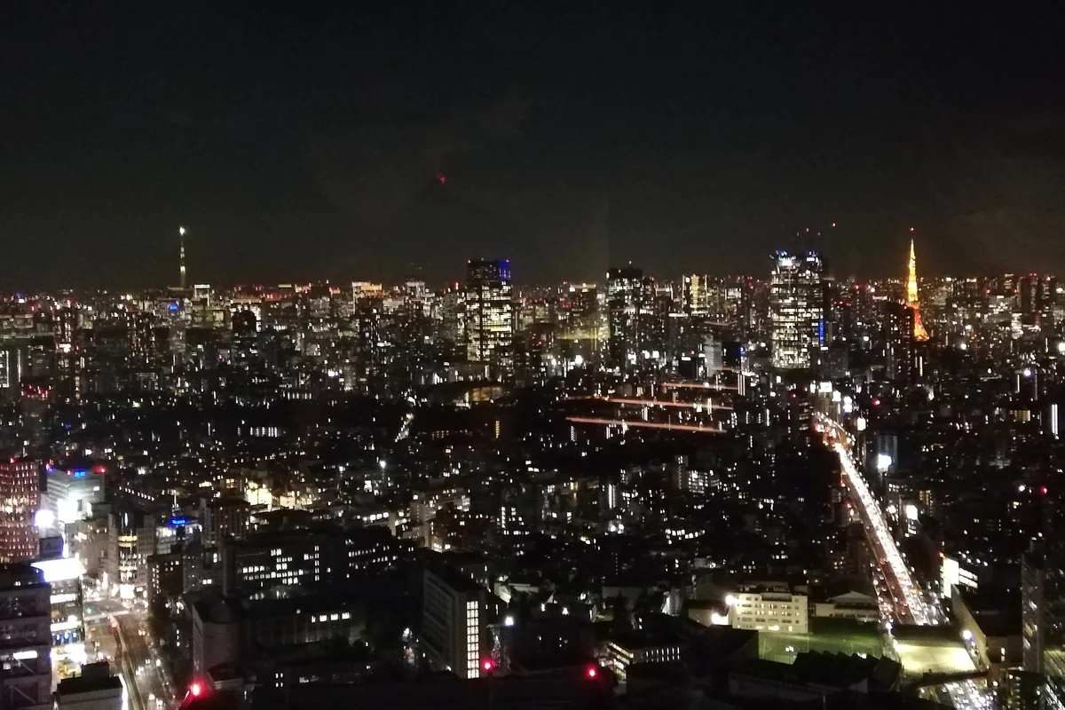 The Shibuya Sky rooftop lit at night above Tokyo