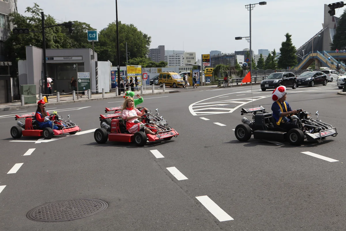 Costumed drivers in go-karts on a Tokyo street
